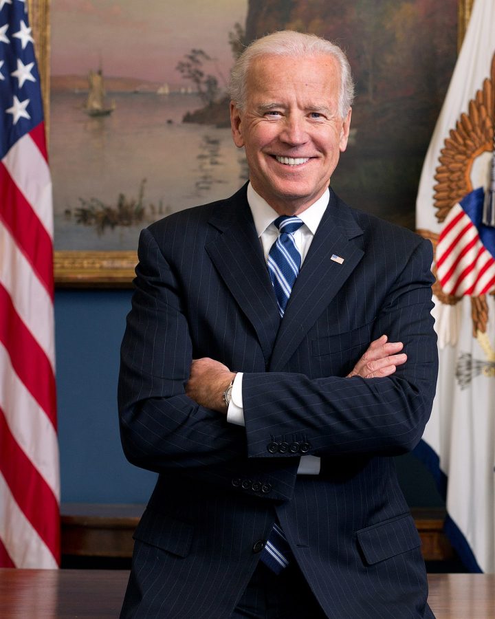 Joe Biden stands next to the American Flag for his official 2013 portrait. He smiles proudly, hoping to represent our country after this election.