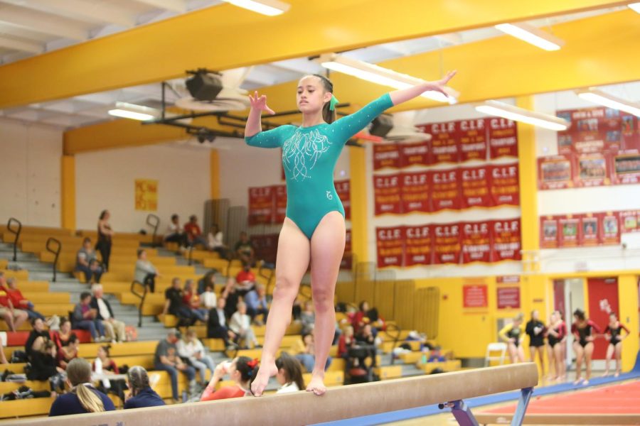 Team Ready: Sophomore Juliana Estacio gets ready to do her beam routine for the judges at the Mt. Carmel tournament on March 25.    
