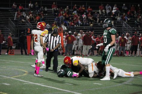 On the ground: A Poway player gets tackled by an Mt. Carmel opponent while attempting to score a touchdown in the end zone during the last home game of the regular season.