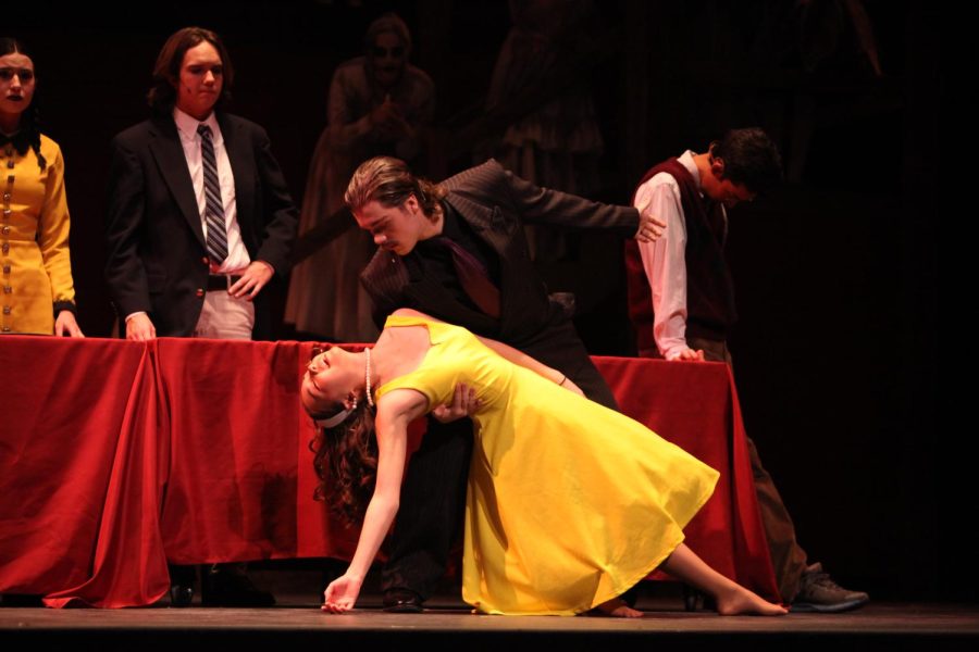 Alice (senior Ellie O’Connell) passes out in Gomez Addams(senior Aiden Betts) arms.
