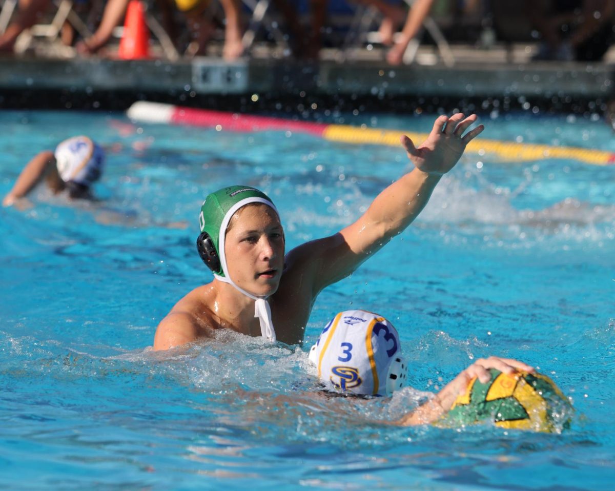 Senior+William+Bayer+reaches+for+the+ball+in+the+varsity+water+polo+game+against+San+Pasqual+where+they+won+with+a+score+of+20-5.