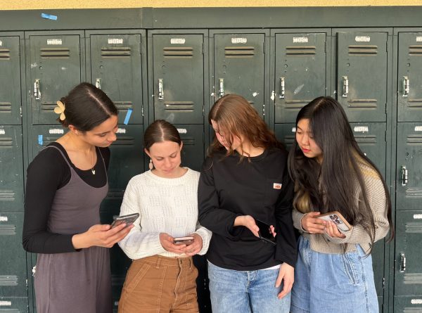 Taking a peek: Students today find information online, seniors Maya Gaudette, Parker Jackson, Evelyn Schreiber, and Kaitlyn Lee take interest of a page on Instagram