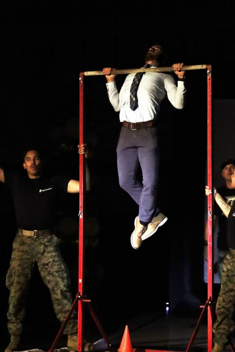 Social Science teacher  Daniel Cook gives his all to be the teacher who does the most pull-ups.