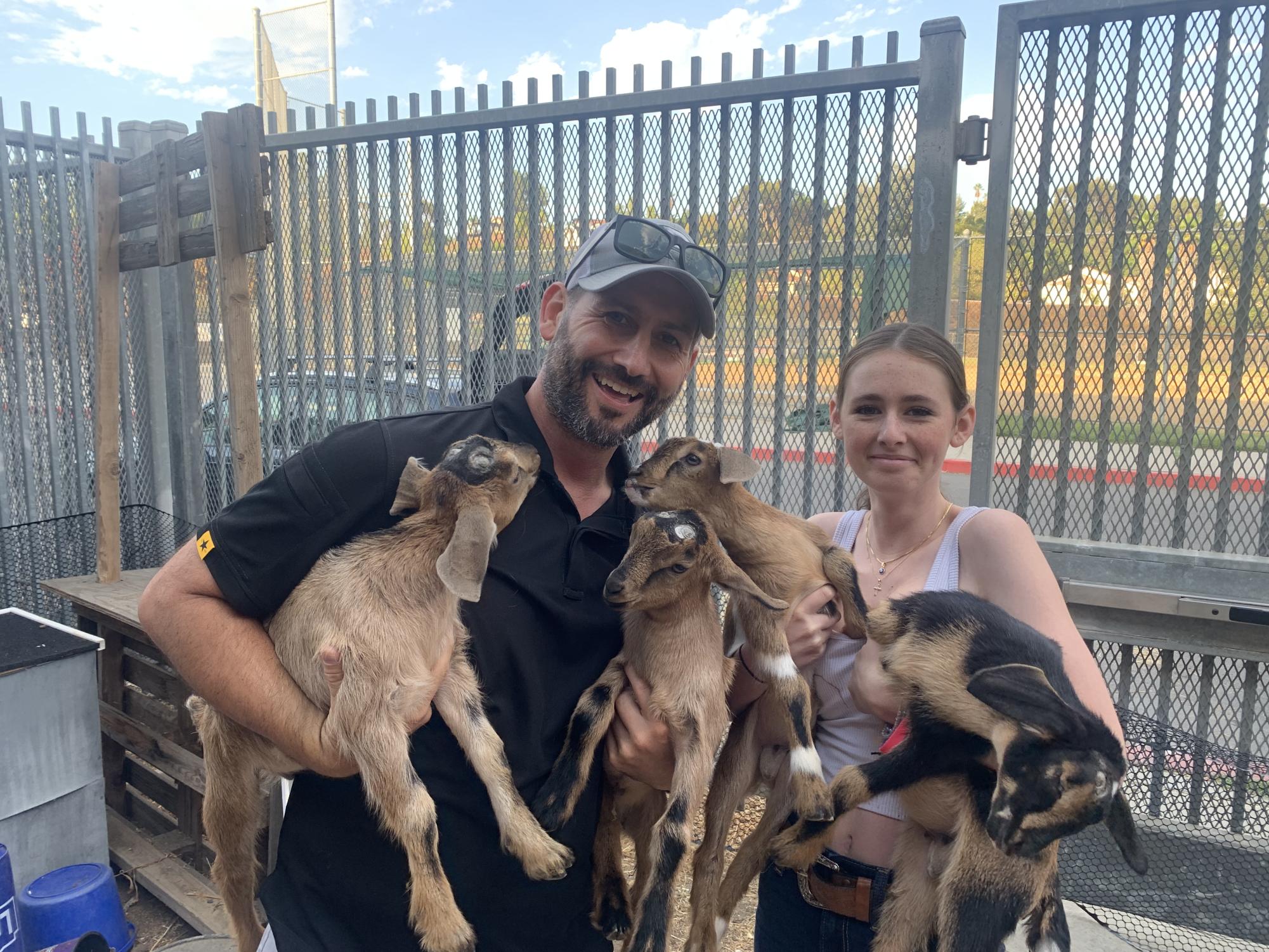  Assistant Principal Michael Gizzo coddles all of his baby goats with his daughter freshman Evie Gizzo.
