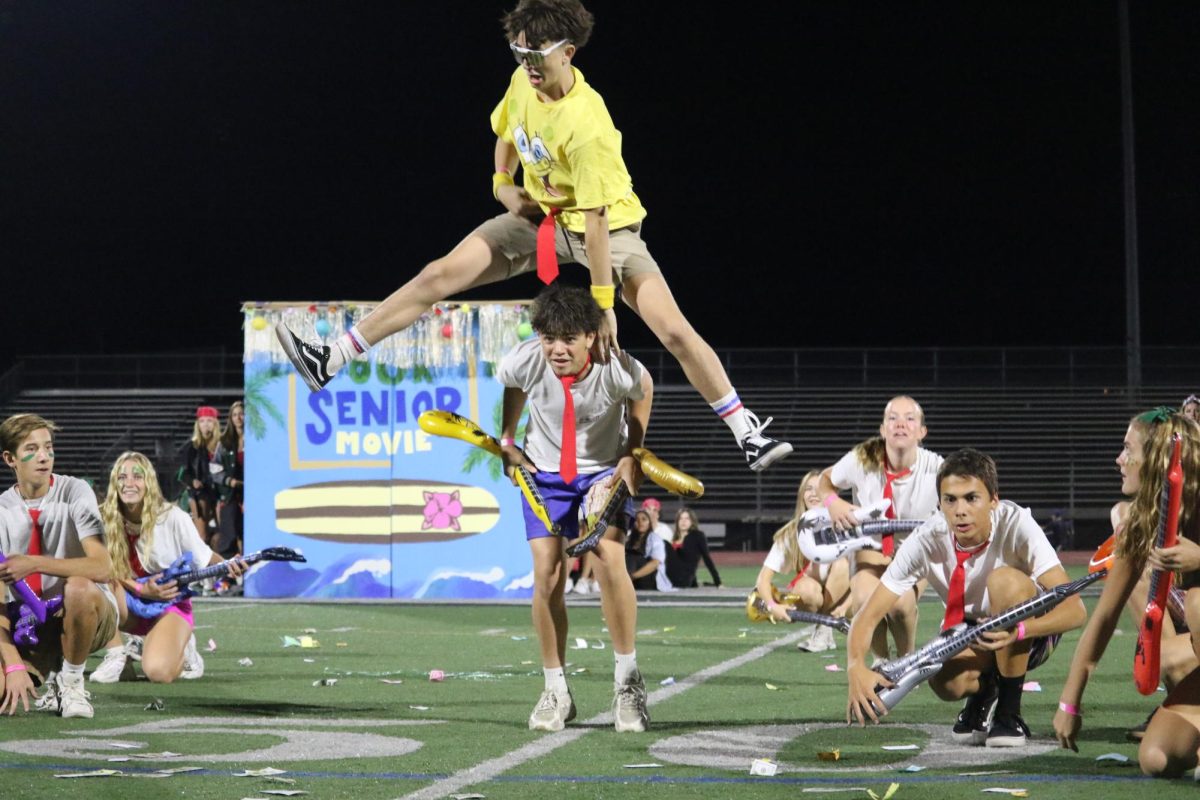 Sophomore Cruz Hintz jumps over sophomore Ryhs Auge during the “Spongebob” dance.