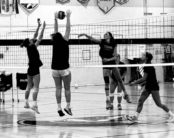 sophomore Gracyn Gregg, senior Grace Thomson. sophomore Ella Bear practice a scrimmage game against each other. They are working to master skills for their next game.    