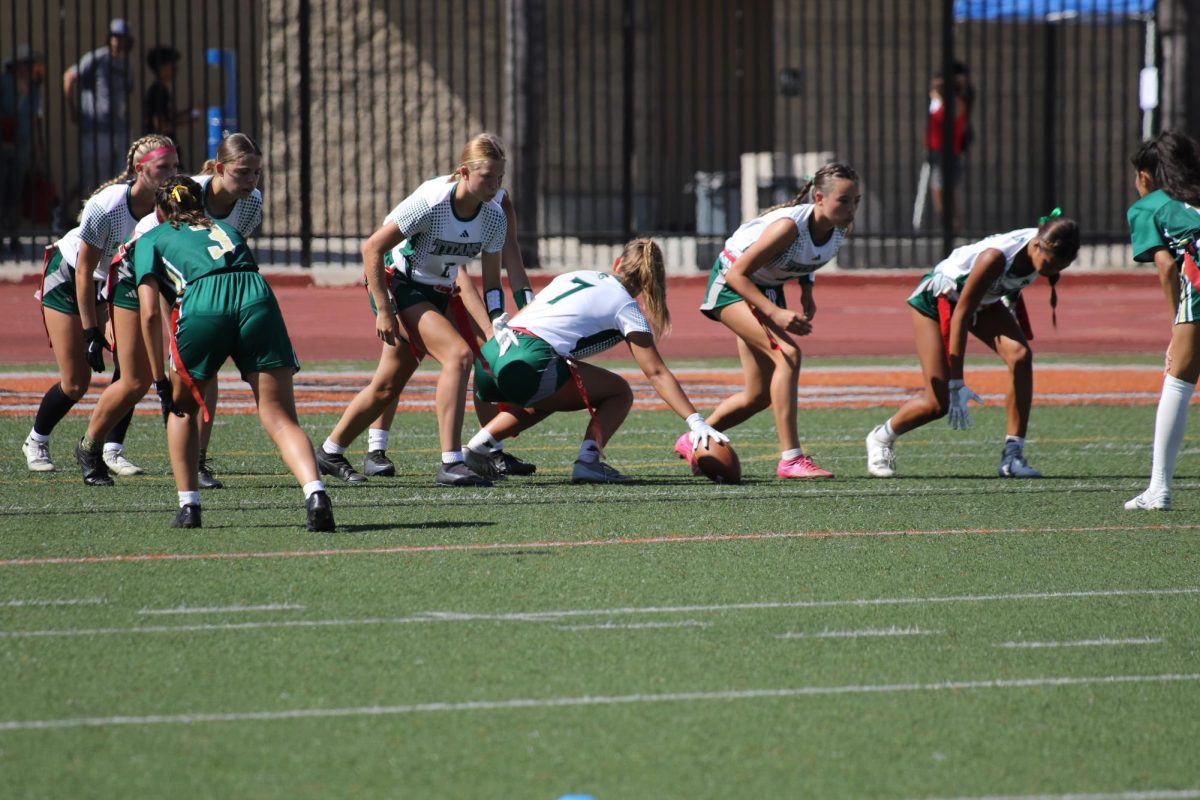  sophomore Delaney Hughes, freshman Hailey Surber, junior Sophie Evens, and senior Avery Hansuvhda setup to run a play on Aug. 24. The new Flag Football team made their debut in a tournament on Aug. 24 at Escondido High School. Their first victory was against Sage Creek High with a final score of 38-0. At the end of the day, Poway came out on top winning all four of their games.                                                                                                                                          