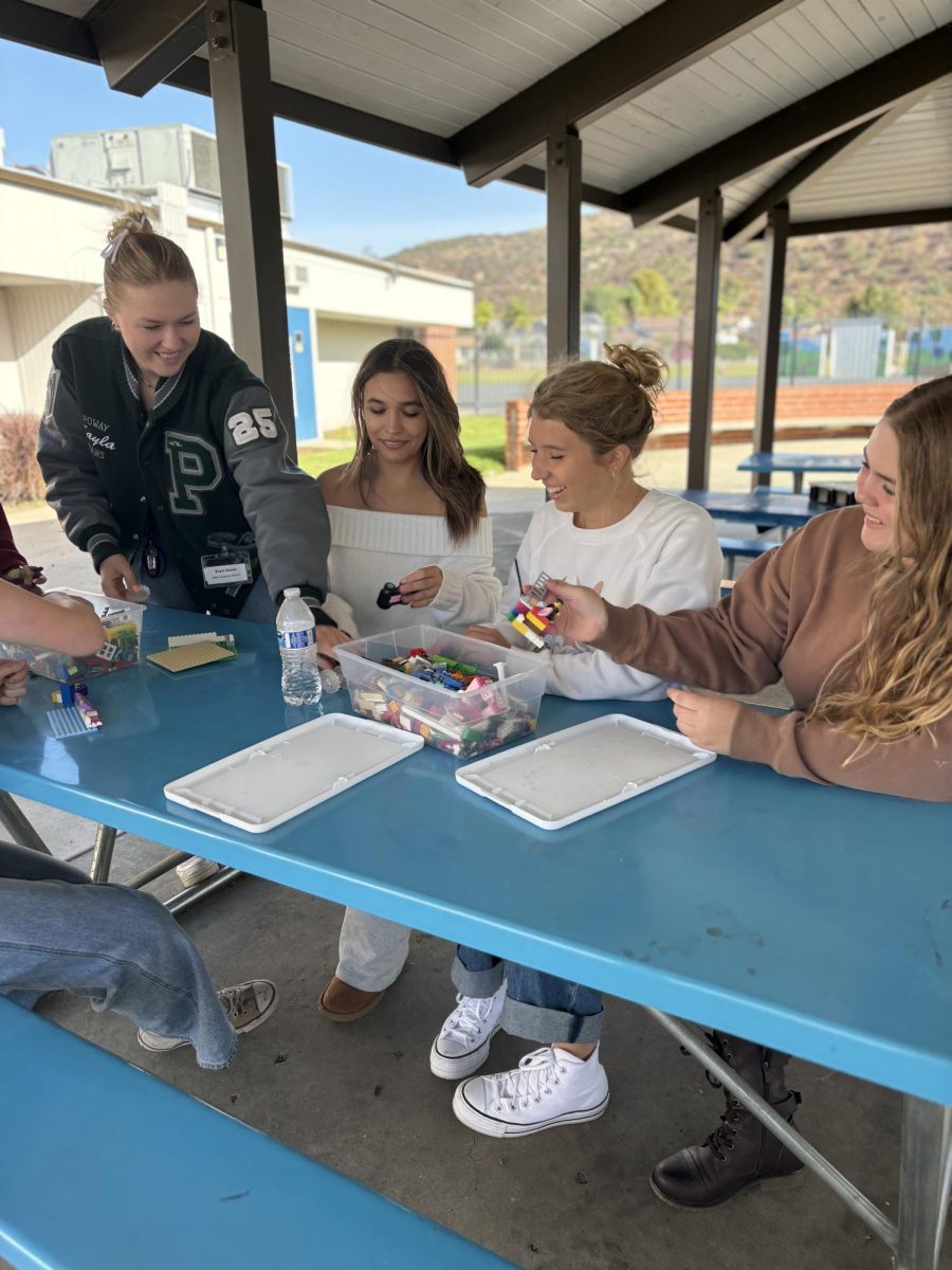 Seniors Kayla Boone, Natalie Hill, Jax Harrell and freshman Grace Olsen play with Lego with buddies at Garden Road Elementary School. They are a part of the Big Buddies program.                    