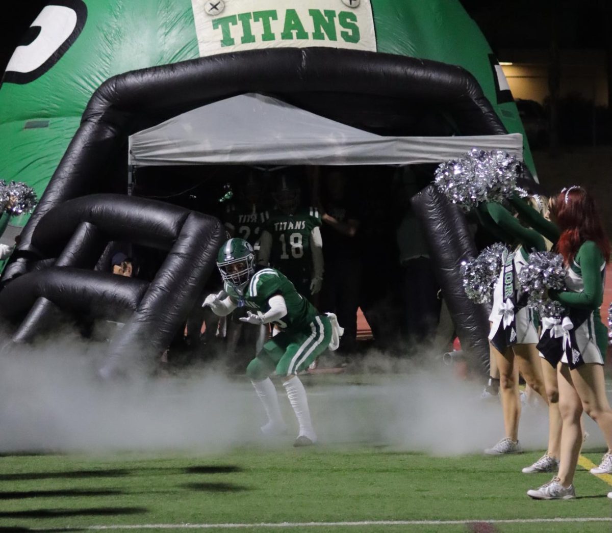 Senior Ryan Crafton performs a celebration out of the tunnel on senior night.