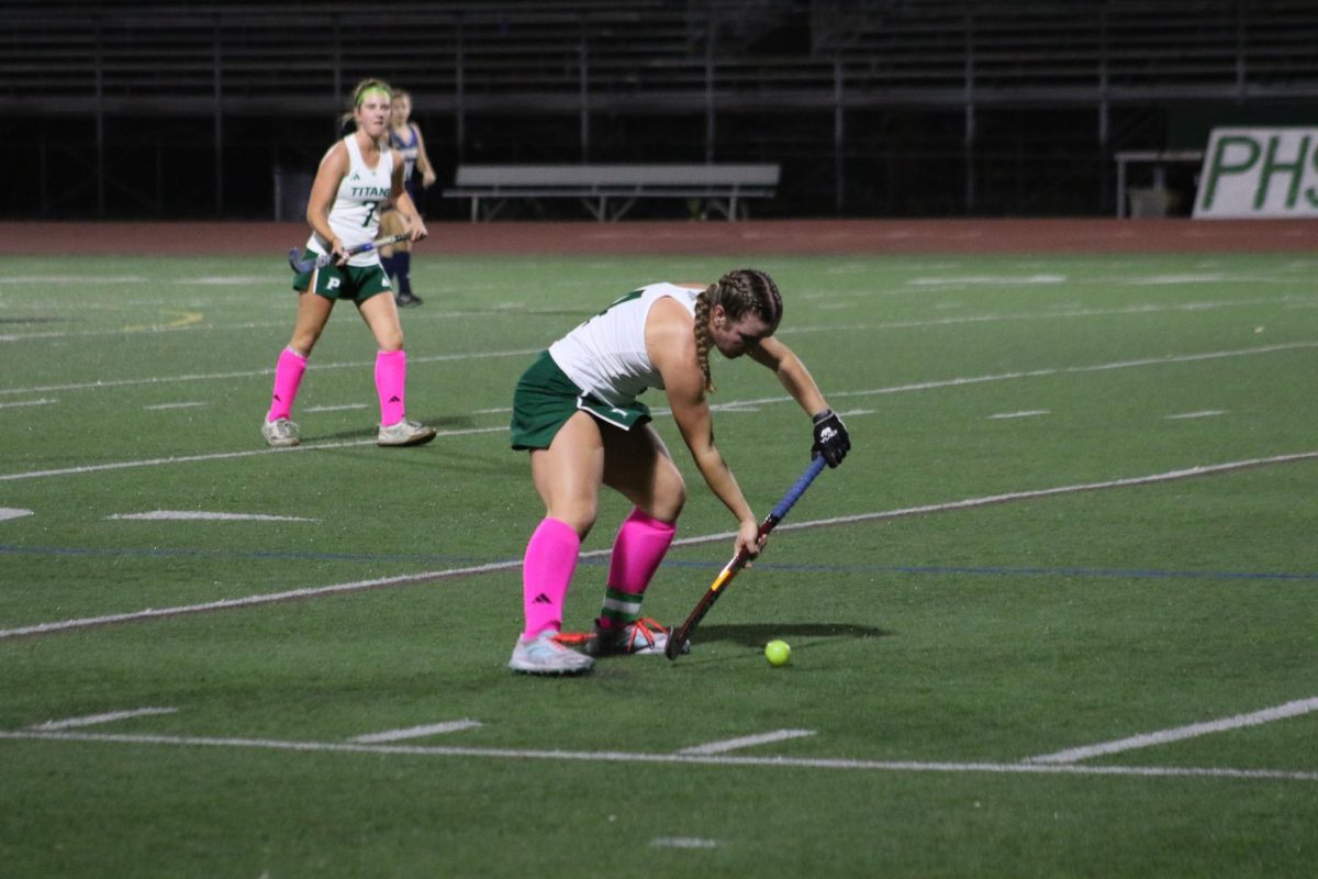 Stick to Success: Senior Sophia Grimm gets ready to stop the ball to pass to her teammate and score a goal. This is Grimms third year on varsity and is currently committed to Cornell University.   