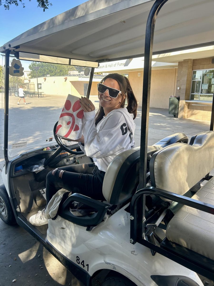 Campus supervisor Tori Ornela displays a typical UberEats delivery.