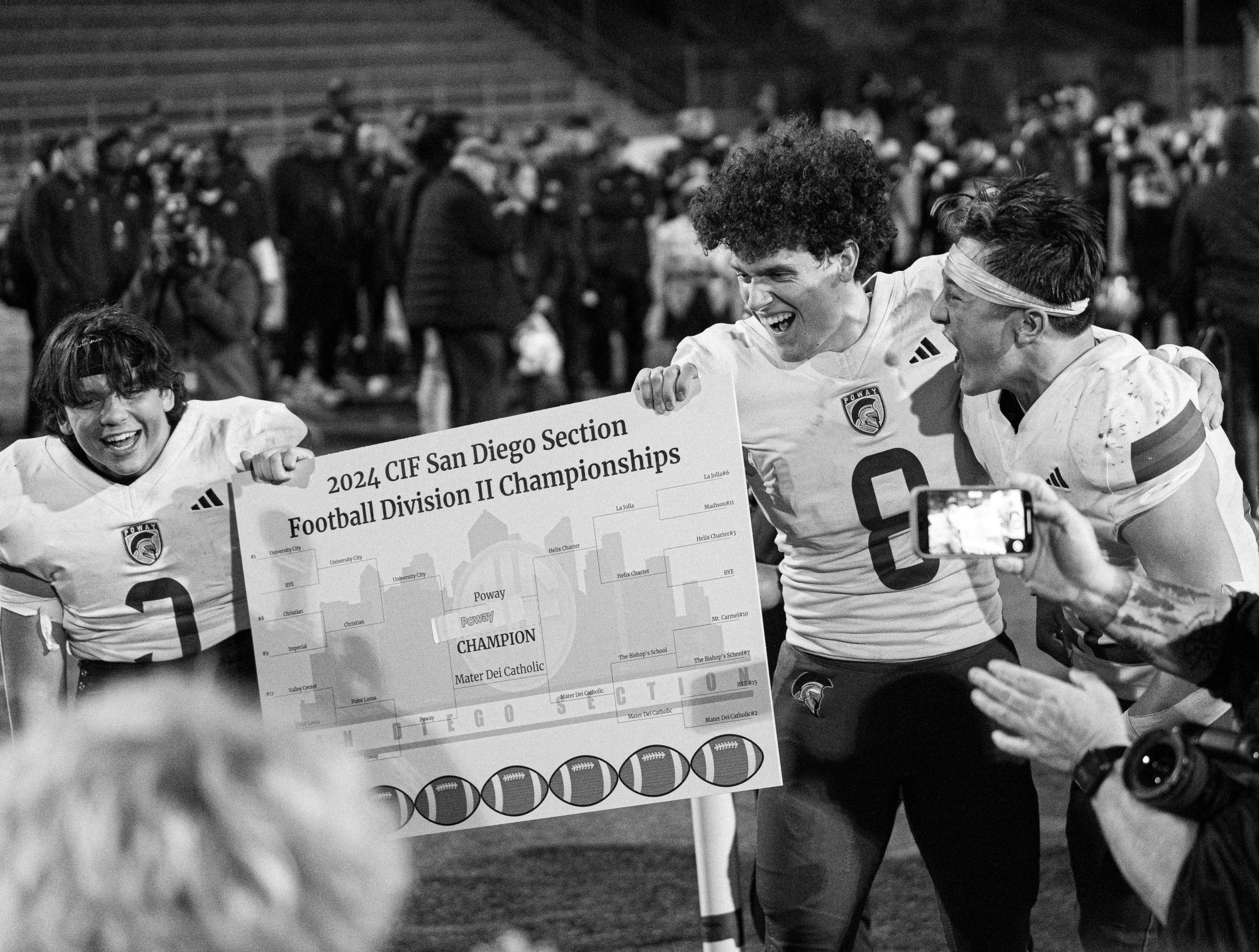 Dashing down the field:  Boys Varsity Football celebrates their Division II champioship win. Seniors Trey Lagoy, Jake Davis, and Jake Tsay hold up their CIF championship win banner. Poway beat Mater Dei 62-24.