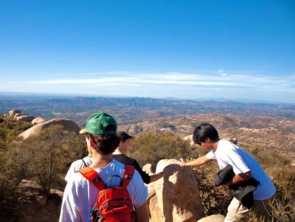 Connecting with nature: Hiking club makes a pit stop during one of their hikes at a beautiful view at Poway Lake. Seniors Gavin Nohara and Kamran Shah examine nature while looking out into the view. 