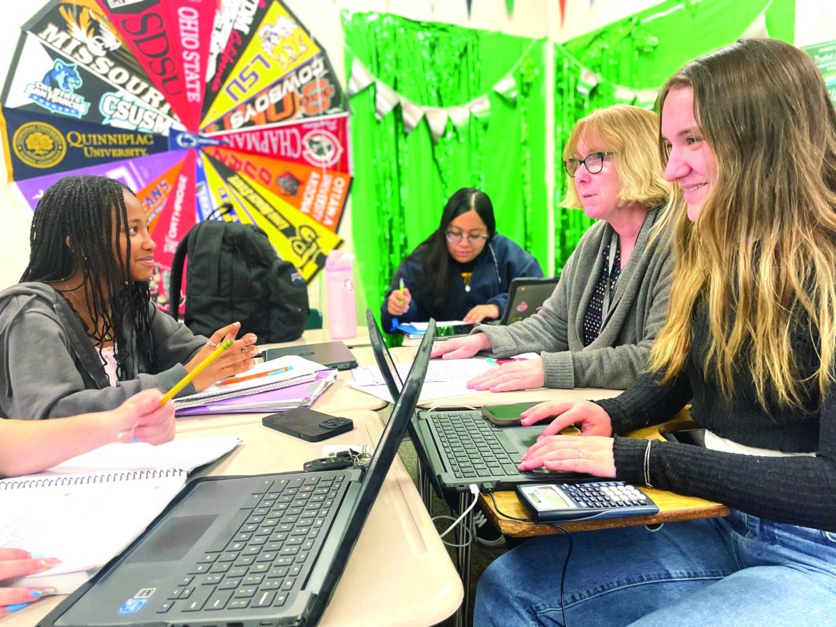 AVID teacher Sherry Lockie is helping juniors Hailey Huey, Madelyn Cedillo-Martinez and Kiana Hardy apply for scholarships to earn money for their college funds. 