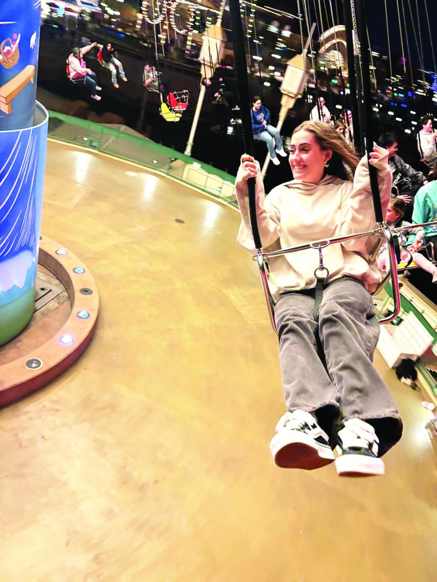 Senior Camryn Perkes smiles as she soars through the sky on the Symphony Swings at California Adventure. 

