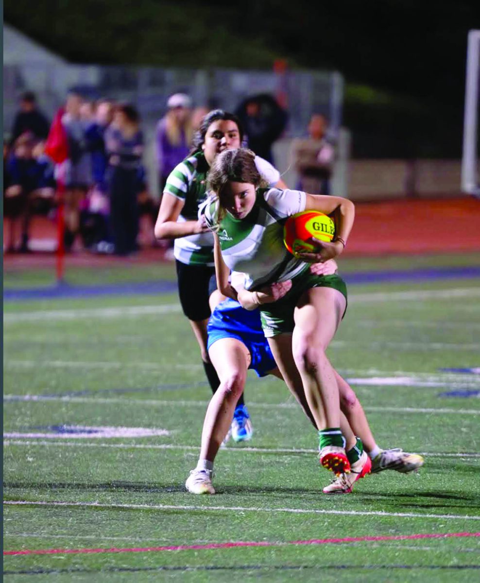 Senior Roxanne Walsh sprints with the
ball attemptng to get away from her opponent.