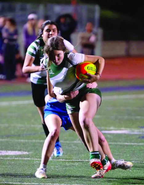 Senior Roxanne Walsh sprints with the
ball attemptng to get away from her opponent.