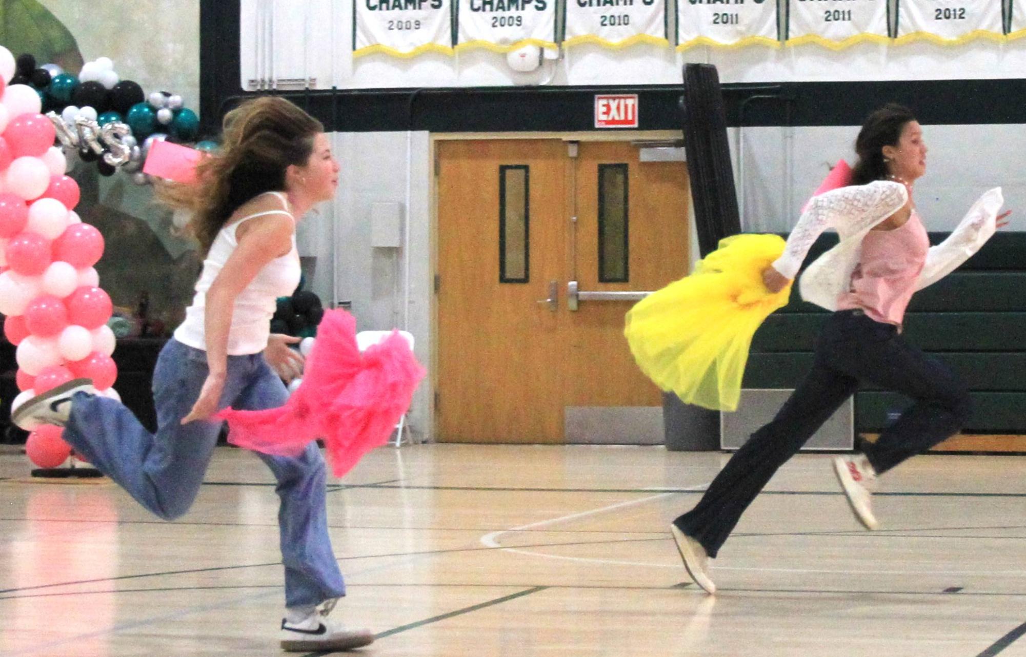 Seniors Reagan Fenter and Regan Meyers race to the end after finding a tutu.  Reagan Meyers won the race to move on in the round.