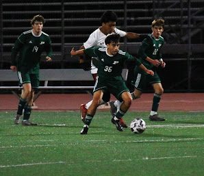 Carlo Gonzalez attempts to get the ball from his opponent.