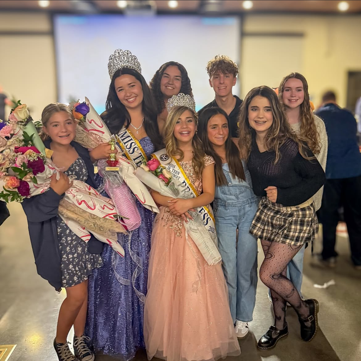 Scarlette Mullengeer stands with her fellow teammates after celebrating winning her Miss Teen Poway title. 