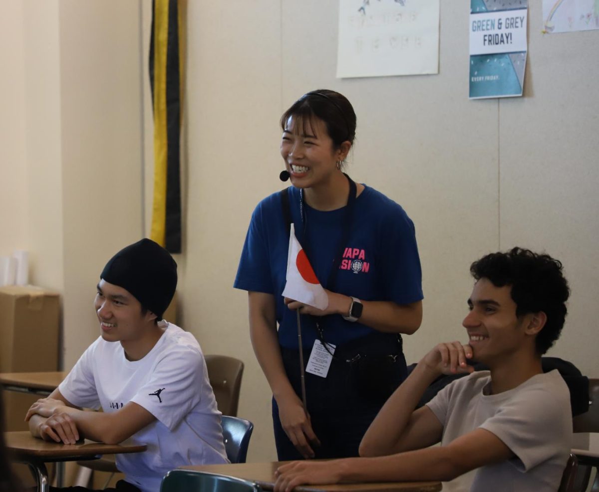 Become a fan of Japan: Japanese teacher Akane Shibaoka laughs with sophomores Lucas Tran and Carlo Cazares while they are working on pronunciation.	      