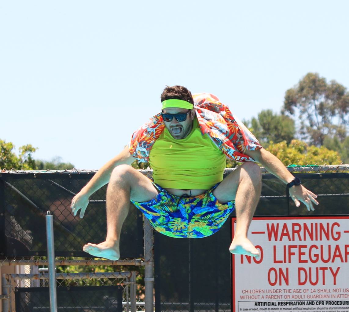 Math teacher Kyle Zeis yells as he tsumo squats into the pool.
