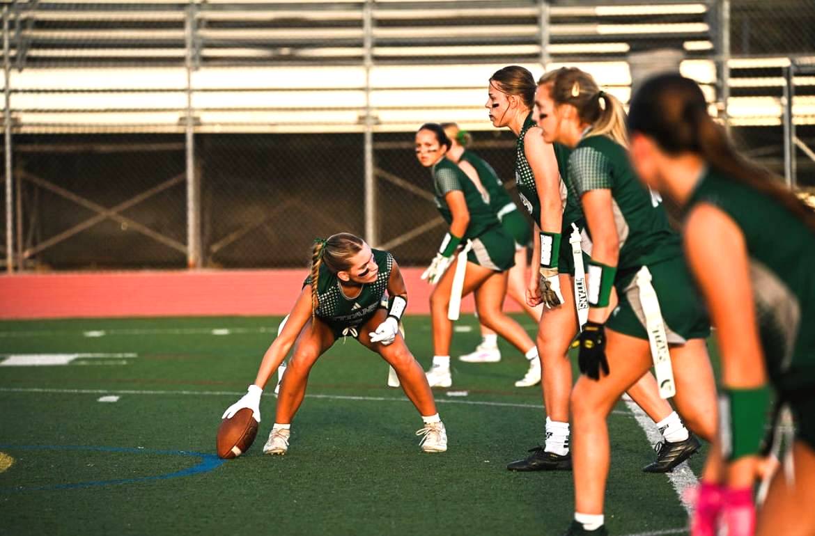 Get ready, set, hike: Varsity Flag Football Captain senior Julia Skalsky sets the ball ready for an offensive play against El Camino on Sept. 18, They won 56-0.