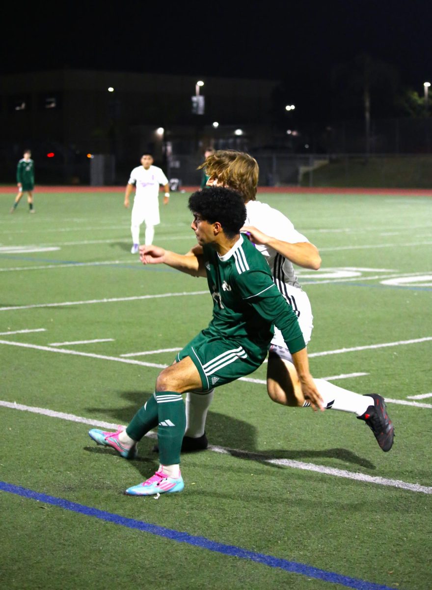 Senior Afshin Jaberizad Hernandez blocks Carlsbad player from stealing the ball. 