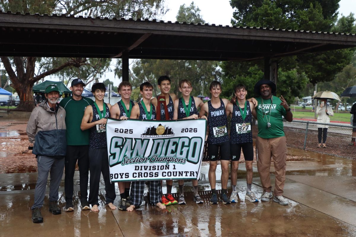 Boys Cross Country stand proudly holding their CIF Division I San Digeo Section banner. 