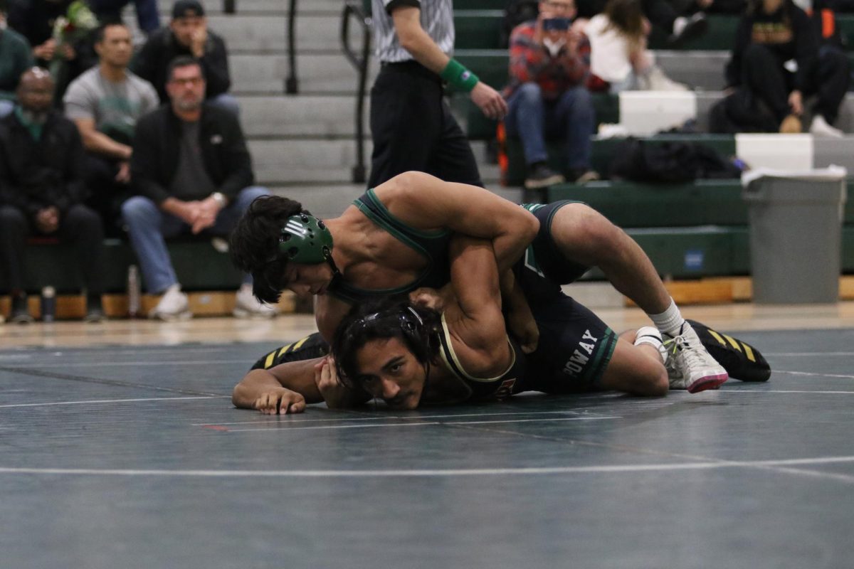 Senior Carlos Valdiviezo locks up his opponent to secure his pin 