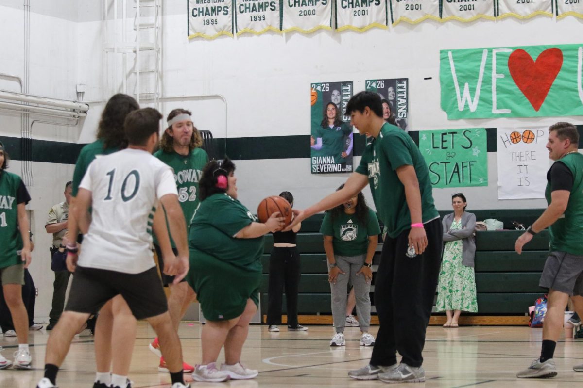 Unified buddy senior Daniel Mariduena passes the ball to Unified player sophomore Kylie Ortega-Lewis. 