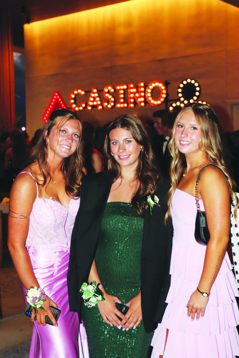 Seniors Natalie Vejtasta, Chanel Xaudaro, and Scarlett Simon pose together for a group photo.